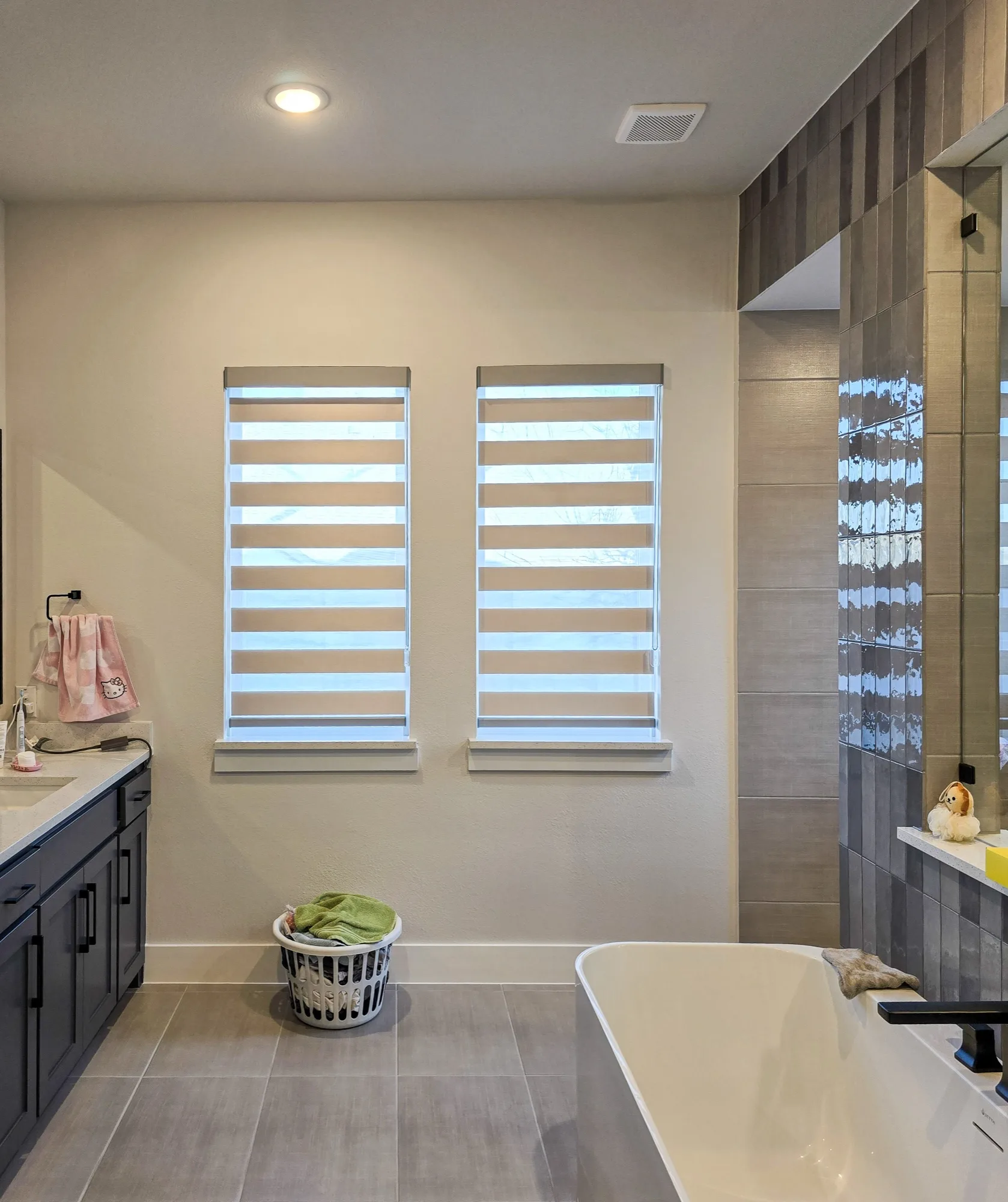 Arapaho light grey blackout zebra shades installed in a McKinney, TX home