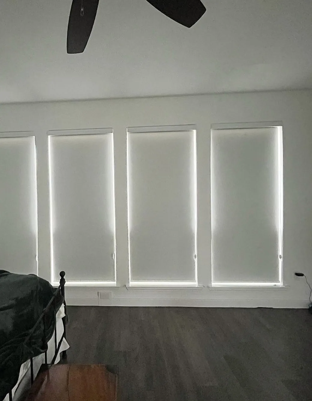 The same bedroom with blackout roller shades lowered