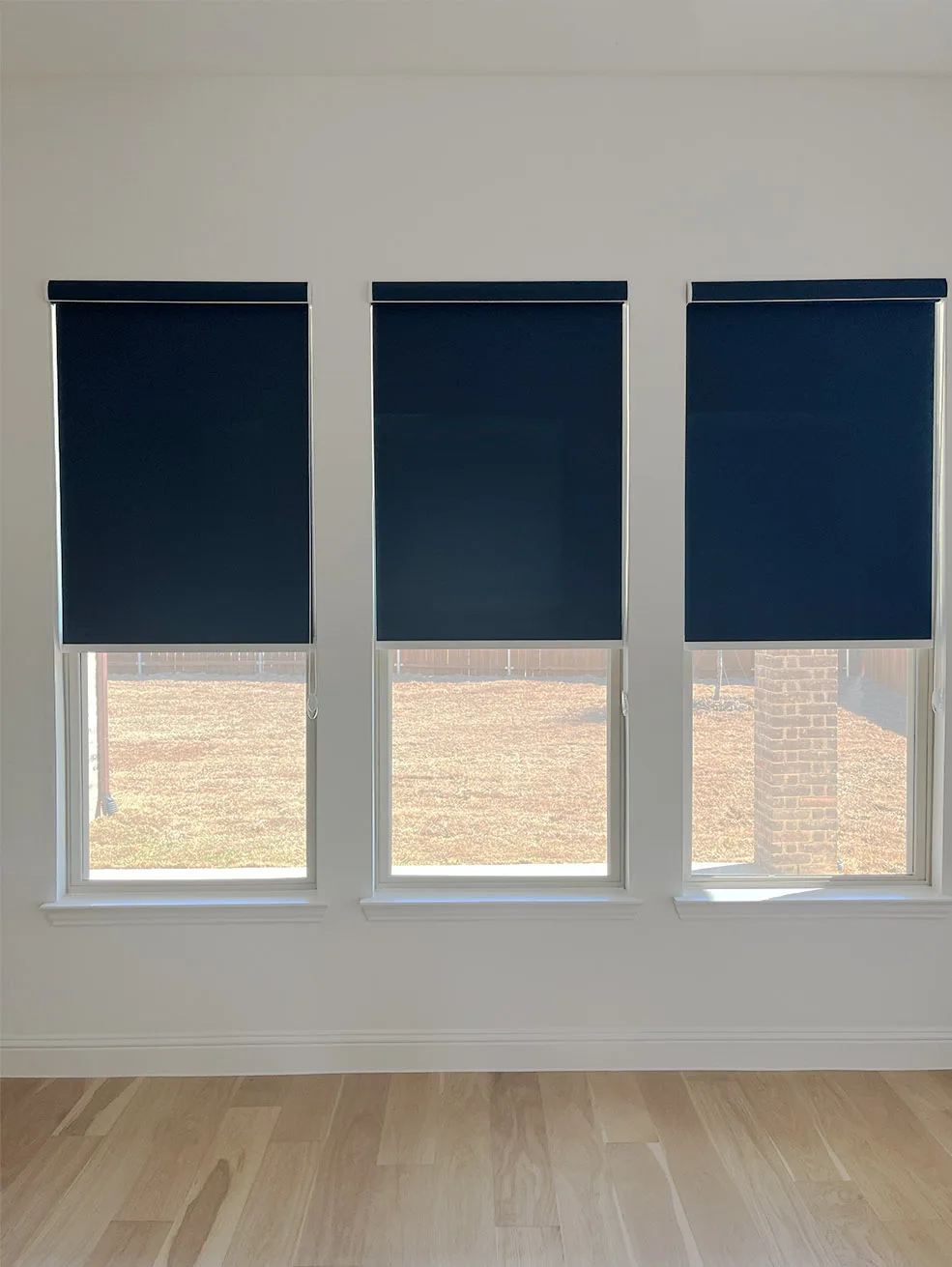 Navy roller shades on three windows