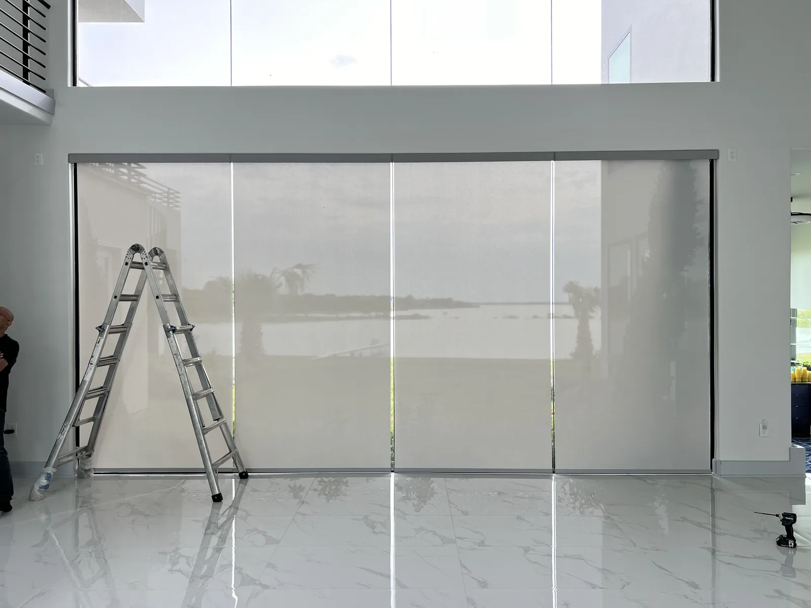 Sunscreen on floor-to-ceiling glass, view still visible