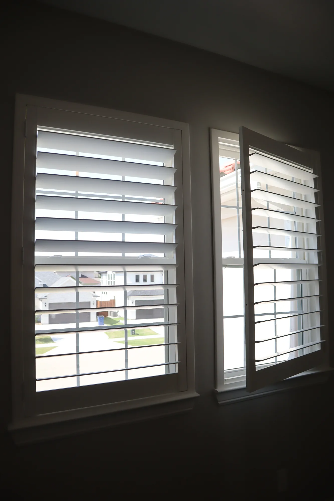 White plantation shutters on two corner windows
