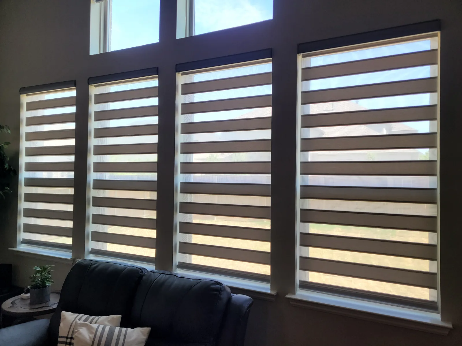 Zebra shades with bands open on living room windows