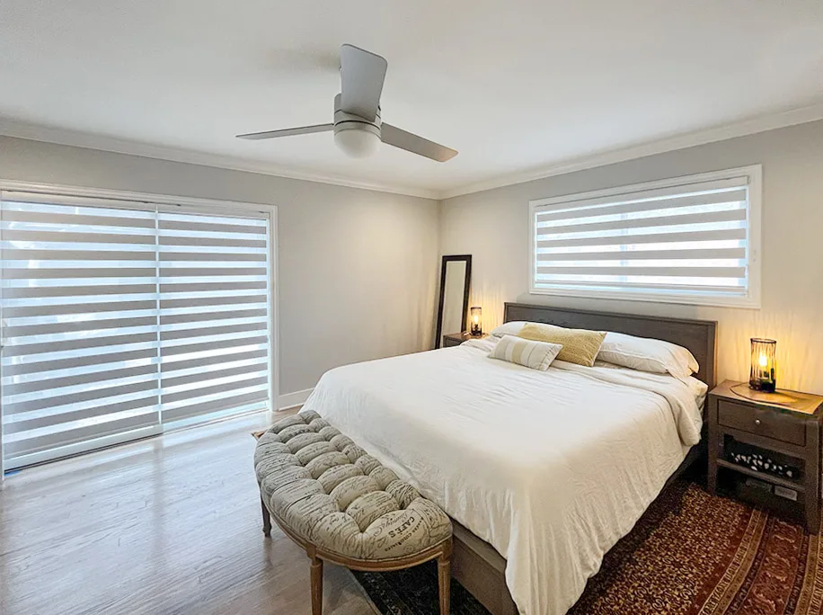 Zebra shades on a sliding door and window in a master bedroom